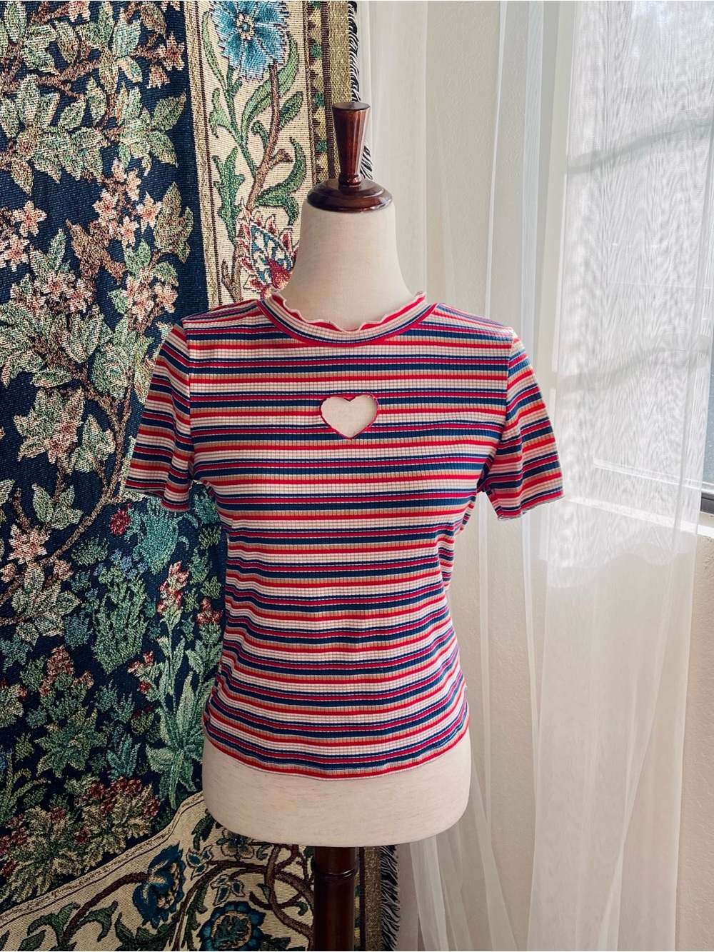 Blue yellow and red striped mock neck top with heart cutout